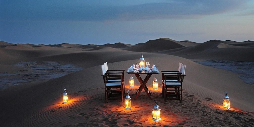 Dinner by candle light in the dunes at Azalai Camp