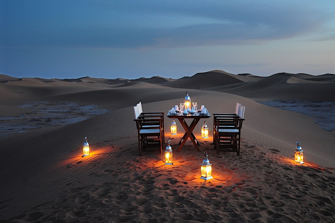 Romantic beachside setup at sunset with champagne and heart balloon, perfect for a Casablanca Morocco honeymoon experience.