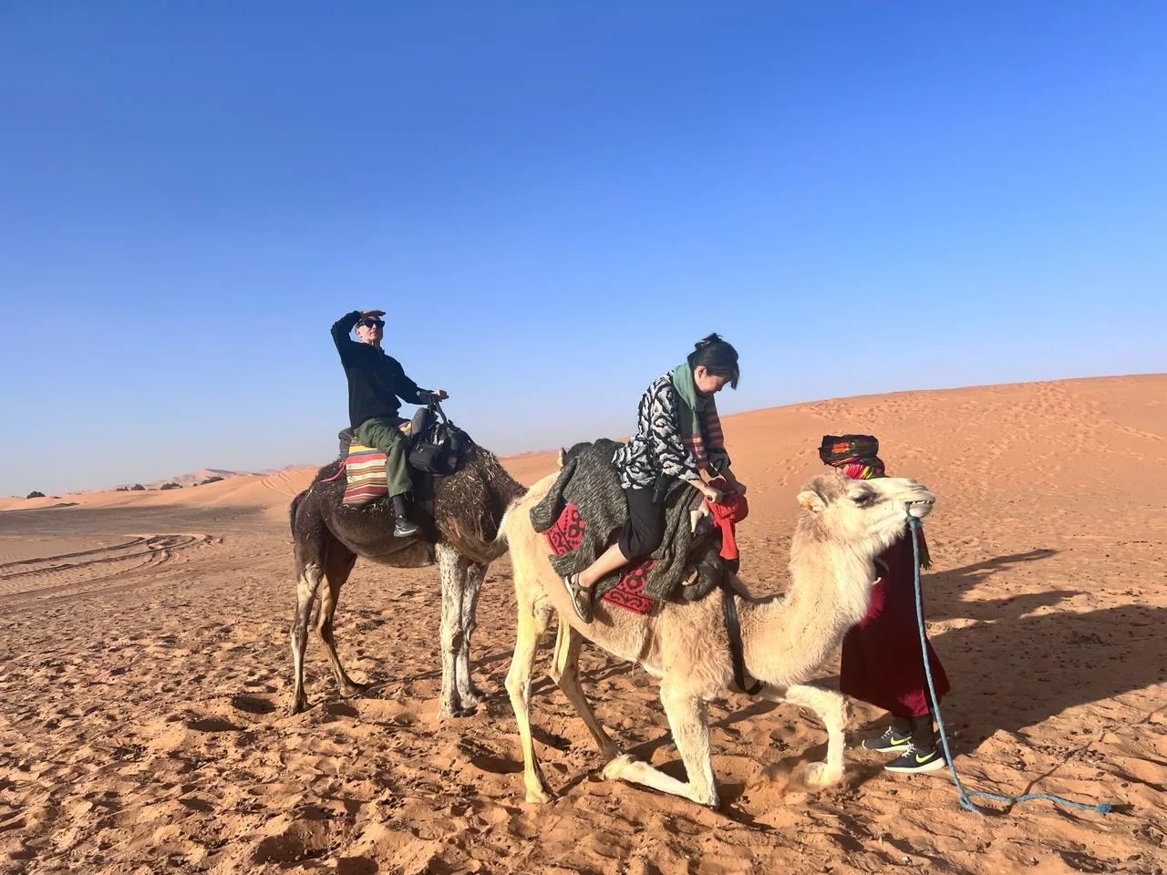 Disembarking from a camel in the Sahara dunes 2023